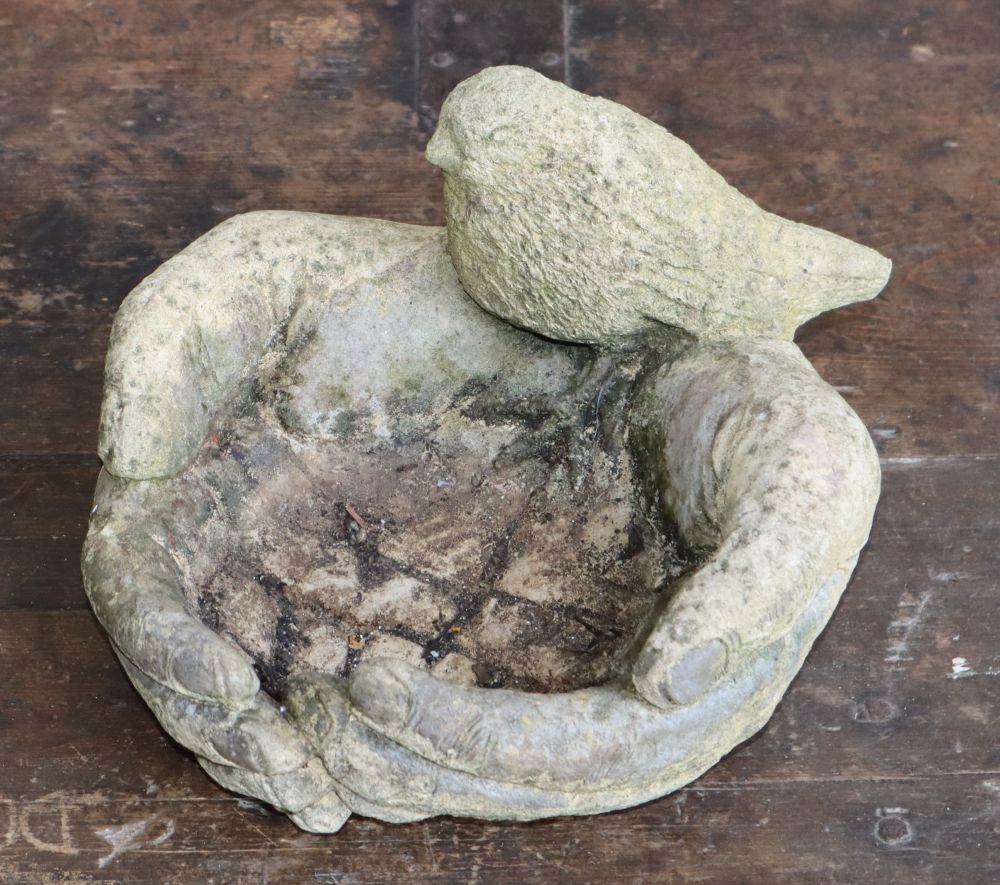 A stone bacchus garden wall mask and a cupped hands bird bath, wall plaque W.23cm, H.33cm,